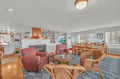 Gather in your spacious open-concept living area with cozy seating, roaring fireplace, and dining for ten.
