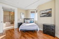 Wake up in your bright, inviting bedroom where warm hardwood floors and a cozy coastal feel set the tone. Step into your private spa-like bathroom, complete with a luxurious soaking tub and spacious walk-in shower.