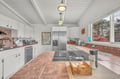Cook your favorite meals in this spacious, fully-equipped kitchen with modern appliances and charming exposed ceiling beams.