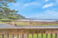 Stunning coastal view from the property deck overlooking pristine beaches and rugged coastline.