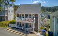 Charming coastal property set in a scenic hillside community with easy access to the beach. The shingled exterior, dual-level balconies, and neighborhood setting highlight a classic Pacific Northwest beach getaway.