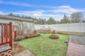 Relax in your private backyard oasis with lush green lawn, greenhouse for fresh herbs, and fire pit for cozy evening gatherings.