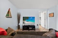Sink into plush seating while tropical scenes fill your big-screen TV in this inviting coastal-themed living space.