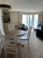 Relax by the window and enjoy stunning lake views from your cozy dining and living space, designed with comfort and tranquility in mind.