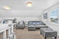 Unwind in your spacious loft bedroom with plush seating and natural light streaming through the windows.