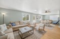 Your bright coastal living and dining space features soft blue walls, comfy seating, and room for everyone to gather. Ceiling fans keep you cool while natural light streams through multiple windows.