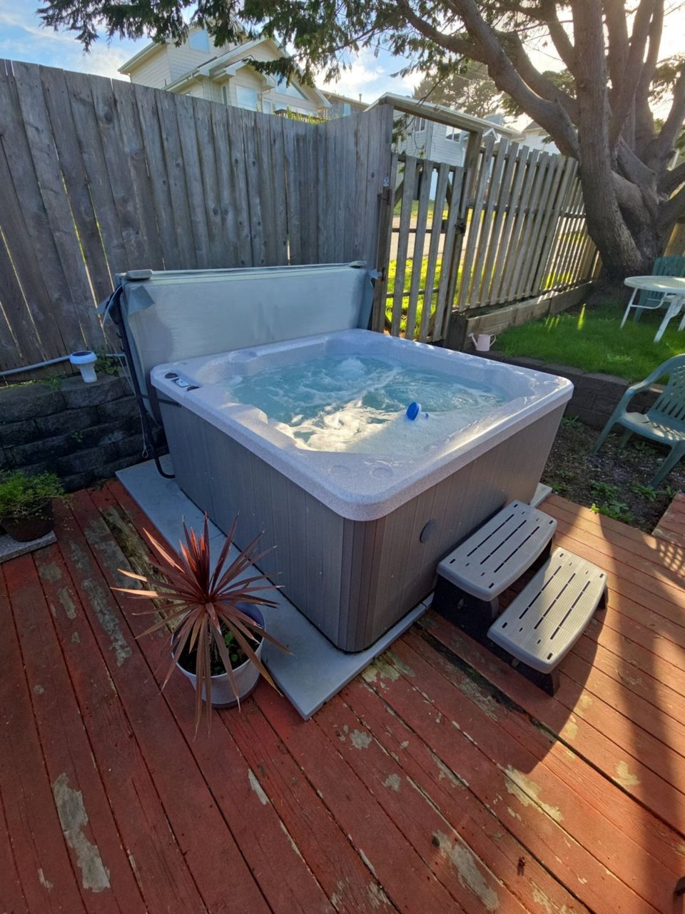 Unwind in your private hot tub on the wooden deck, surrounded by mature trees and complete privacy for the perfect evening soak.