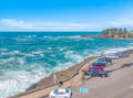 Stunning coastal parking area with direct ocean access and spectacular sea views across turquoise waters.