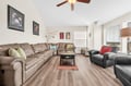 Stretch out on plush sectional seating in your spacious living room, where modern comfort meets warm wood tones and natural light.