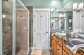 Luxurious bathroom with granite counters, colorful tile accents, and spacious walk-in shower for your relaxing getaway.