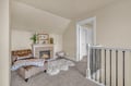 Cozy upstairs lounge where you can curl up by the fireplace with soft throws and elegant furnishings.