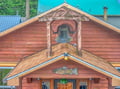 Distinctive rustic property featuring charming wooden exterior with decorative bell tower, unique fish artwork, and vintage architectural details surrounded by natural forest setting.