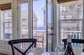 Coastal charm framed by classic architecture—your seaside getaway awaits just beyond the balcony, where ocean breezes meet weathered shingles and endless blue horizons.
