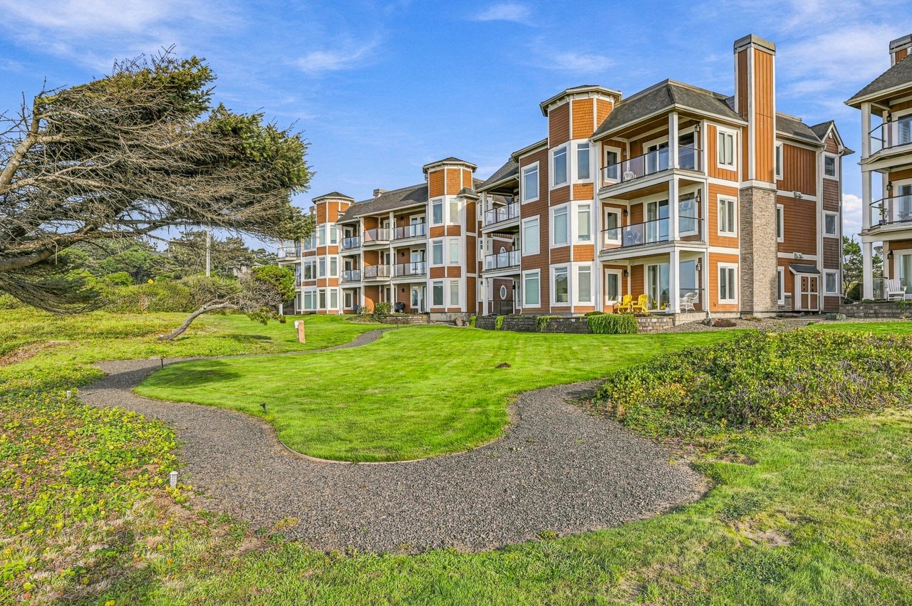This coastal property features well-maintained grounds with mature landscaping and walking paths, offering easy access to the area's natural beauty and surrounding amenities.