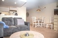 Settle into your open-plan living space where a plush sofa invites you to unwind, and a cozy dining table awaits your meals and conversations.