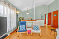 Settle into your peaceful living space with calming sage walls, cozy seating, and cheerful touches throughout this bright, welcoming retreat.