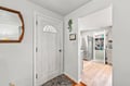 Step through the charming front door into your welcoming entryway, where light-filled spaces flow seamlessly into a bright, fully stocked kitchen ready for your home-cooked meals.