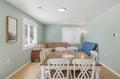 Gather around your generous dining table, where natural light and soothing coastal tones create the perfect backdrop for shared meals and lasting vacation memories.