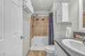 Step into your pristine bathroom with natural stone details, crisp white linens, and a refreshing walk-in shower.