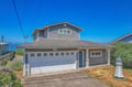 Charming coastal home with garage parking and decorative lighthouse, nestled in a peaceful residential area.