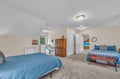 Unwind in your spacious shared bedroom with twin beds, cozy blue linens, and charming coastal touches that create the perfect retreat.