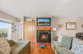 Sink into plush sofas by the fireplace and let your worries melt away in this bright, welcoming living room with lake views through the door.