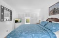 Drift into peaceful slumber in your tranquil bedroom featuring soft blue florals, built-in storage, and entertainment for cozy evenings.