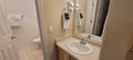 Step into your private bathroom, where fresh towels await on the mirror and crisp white tiles underfoot promise a clean, comfortable stay.