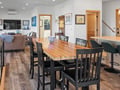 Your open-plan dining area flows seamlessly into the living space, featuring warm wood tones and modern comfort for memorable meals together.