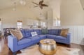Sink into the plush blue sectional and unwind. Vaulted ceilings and coastal touches create your perfect retreat, where relaxation comes naturally.