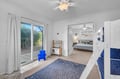 A welcoming space opens to a sunny patio with lush greenery, offering you plenty of room to unwind. The adjacent bedroom gives your group comfortable sleeping arrangements, while the kid-friendly play furniture sparks imagination and fun.