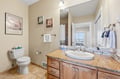 Step into a bright, thoughtfully designed bathroom with warm tones and coastal charm. The granite countertop, spacious vanity, and fresh towels make getting ready feel like a spa-like treat each morning.