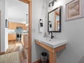 Refresh in your stylish bathroom with modern fixtures and sleek vanity, while glimpsing the fully-equipped kitchen just steps away.