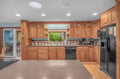 Step into your fully-equipped kitchen with warm wood cabinetry, modern appliances, and everything you need to whip up your favorite meals. The space opens to a lovely outdoor patio for easy entertaining.