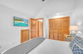 Your peaceful bedroom features crisp linens, vaulted ceilings, and warm wood accents that create the perfect tropical retreat.