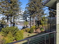 Stunning lakefront views stretch across pristine waters from your private balcony, surrounded by mature trees and thoughtfully landscaped gardens.