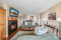 Curl up on plush sofas in your warm living room, where a crackling fireplace creates the perfect ambiance for cozy evenings with loved ones.