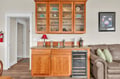 Unwind with your morning coffee or evening wine at this elegant wet bar, complete with wine fridge and beautiful glassware display.