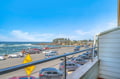 Oceanfront balcony overlooking the Pacific coastline with convenient beach parking below.