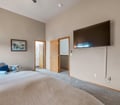 Your spacious bedroom features high vaulted ceilings, a large TV for movie nights, and direct access to your private bathroom and walk-in closet—a peaceful retreat to unwind after exploring.