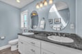 Your spacious bathroom features dual vanities with granite counters, perfect for sharing morning routines in elegant comfort.