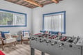 Challenge friends to a foosball match in your private game room, where exposed beams and cozy seating create the perfect retreat.