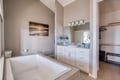 Unwind in your spa-like master bathroom, featuring a deep soaking tub perfect for evening relaxation after exploring the area.