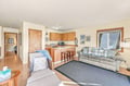 Relax in your open-plan living space where natural light floods the room. Unwind on the couch, prepare a meal in your kitchenette, and enjoy cozy comfort as your home away from home.