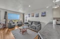 Unwind in your spacious living room with ocean views, cozy seating, and coastal artwork that brings the beach right to your doorstep.
