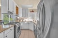 Your fully equipped kitchen features granite counters, stainless steel appliances, and a bright window overlooking greenery—perfect for cooking memorable meals.