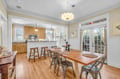You'll love gathering around this warm wooden dining table where the open kitchen design makes meal prep part of the conversation.