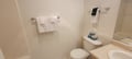 Your private bathroom features crisp white tile, fresh towels, and everything you need to refresh after a day exploring.