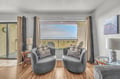 Unwind in plush swivel chairs while enjoying stunning views through floor-to-ceiling windows that frame the endless horizon.