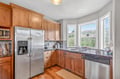 Cook with mountain views in your fully equipped kitchen featuring stainless steel appliances and warm wood cabinetry.